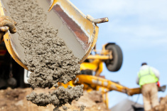 stock photo 22798089 construction worker guiding cement mixer truck trough